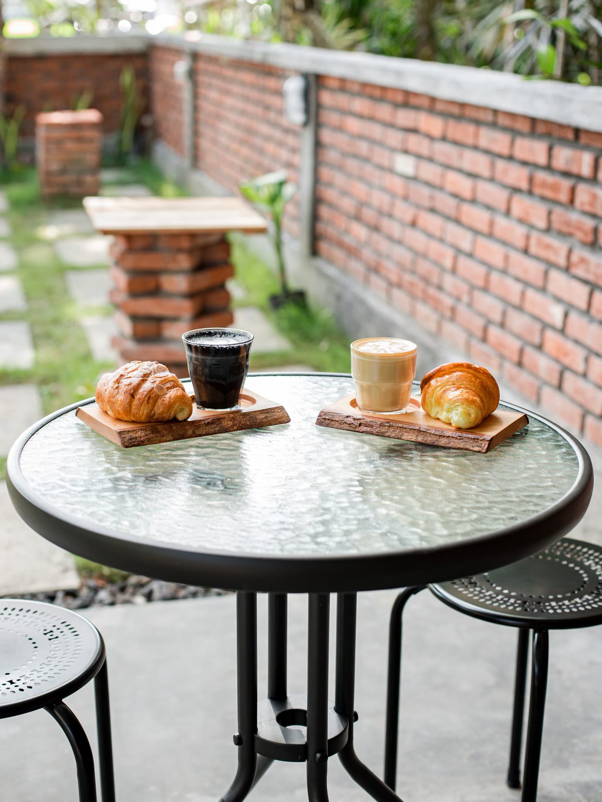 Coffee and croissants on a round patio table