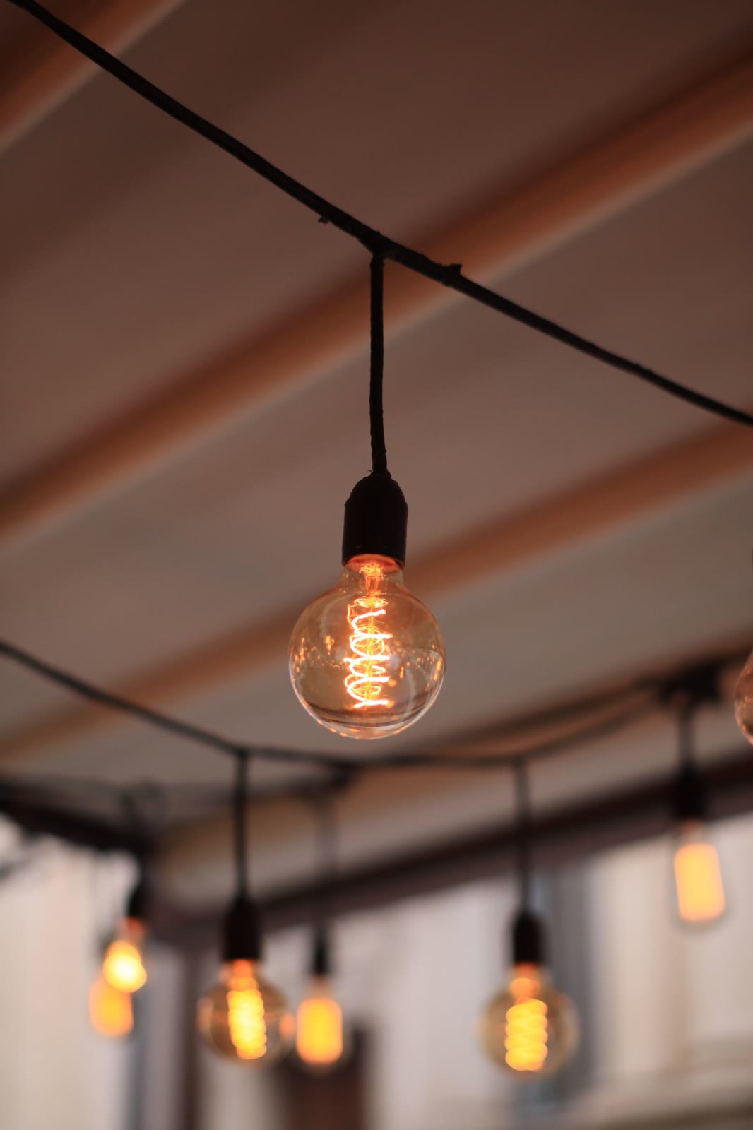 Warm bulbs hanging under a patio awning