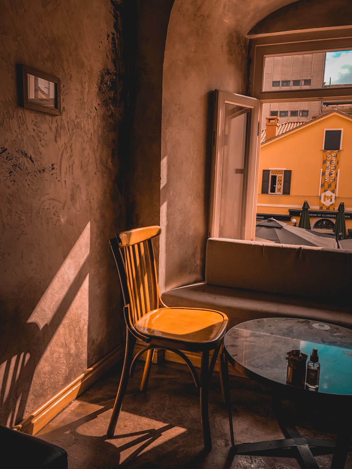 Wooden chair in golden evening light by an open window