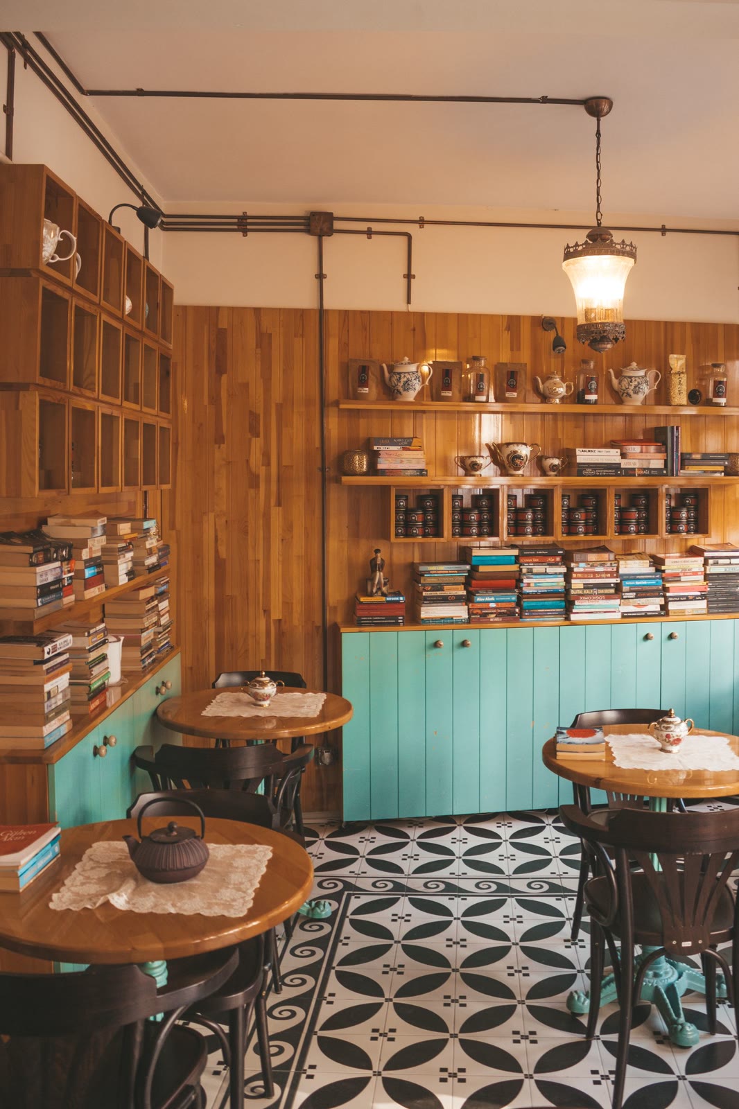 Cozy café interior with bookshelves and patterned floor tiles