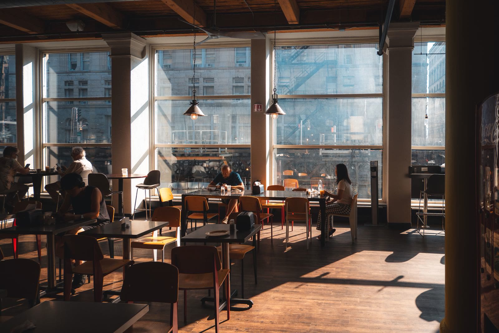 Café interior with tall windows and warm afternoon light