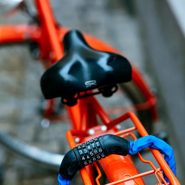 Combination lock on an orange bicycle