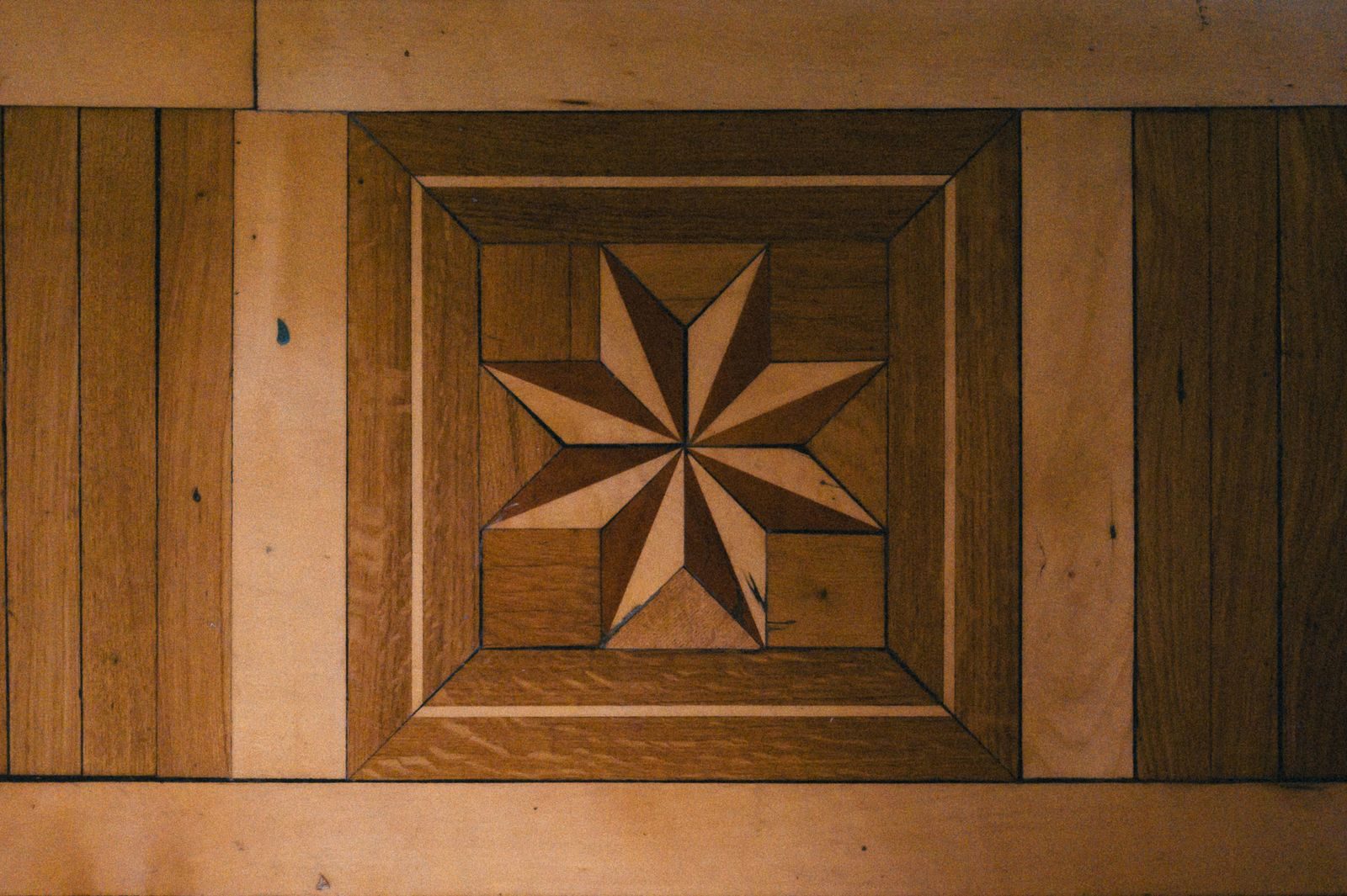 Wood floor inlay with a star medallion