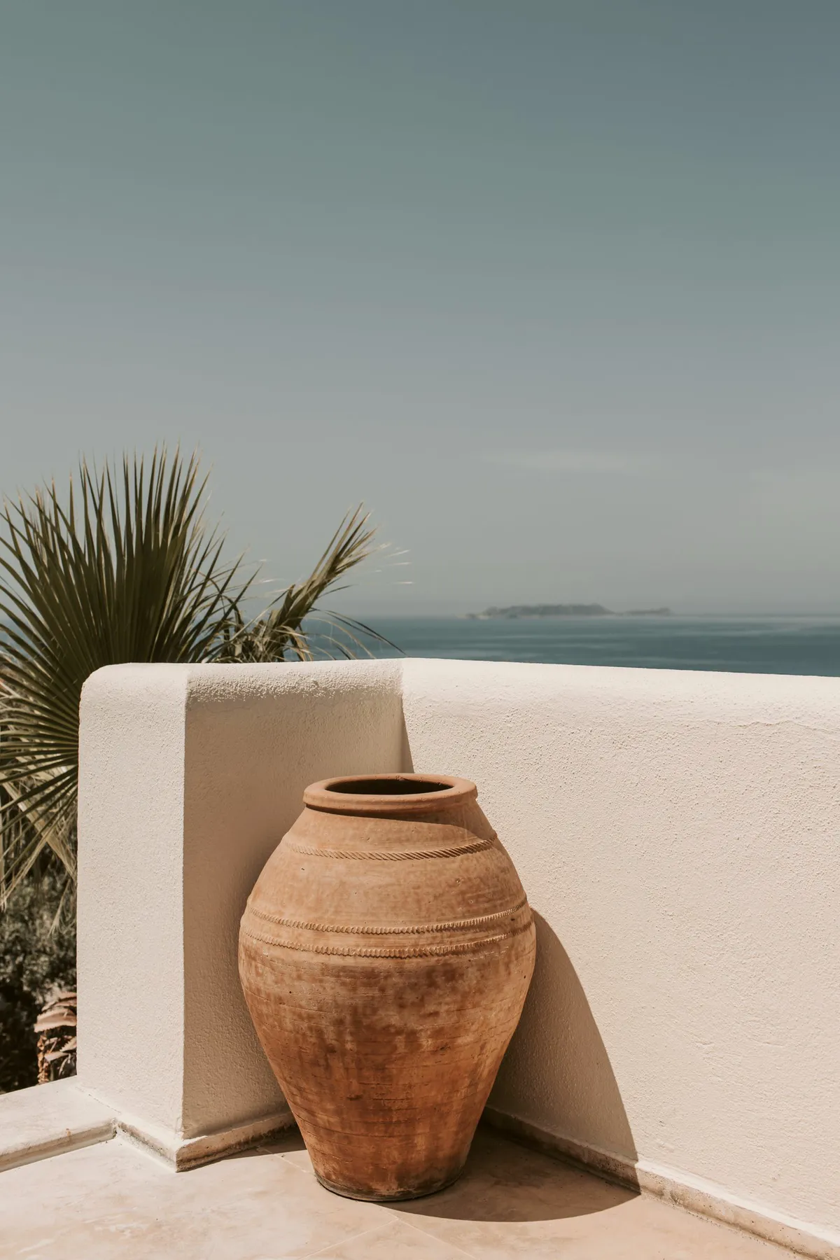 Clay jar on a white terrace wall