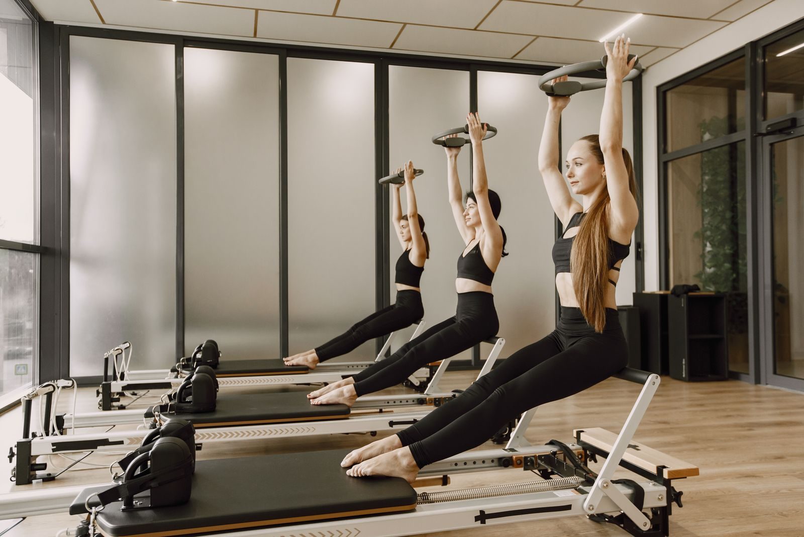 Small reformer class working with pilates rings