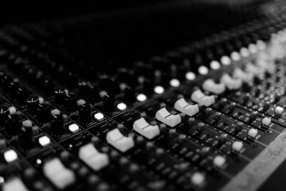Close view of faders and channel lights on a mixing desk