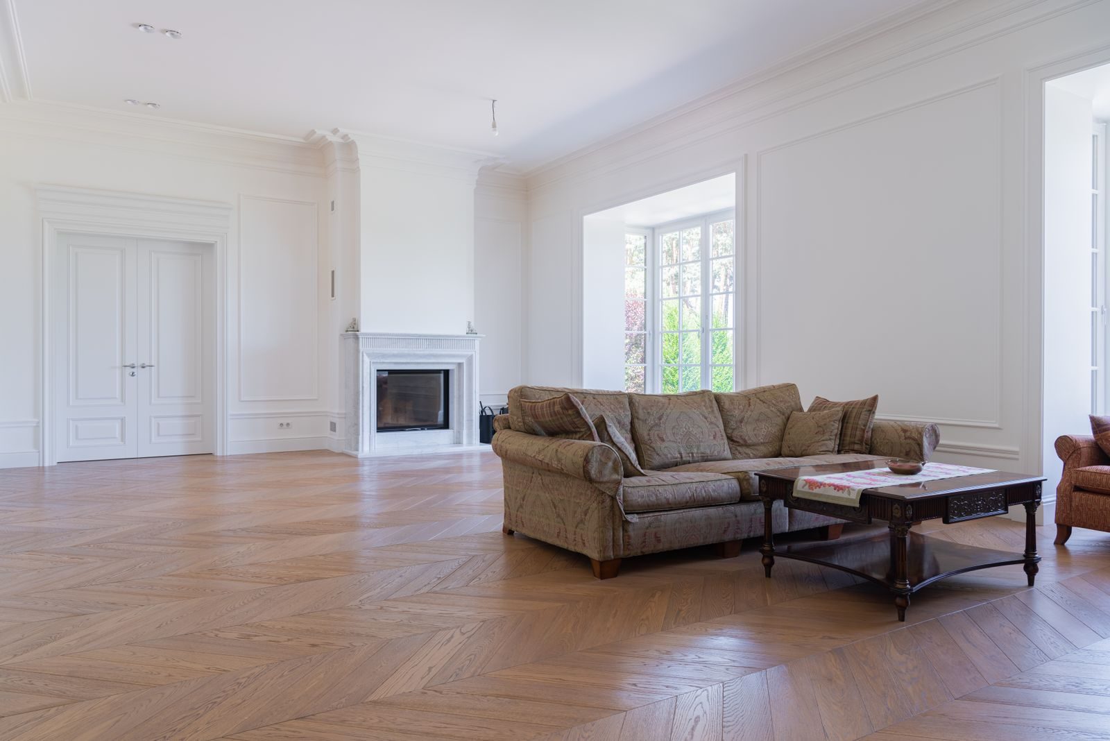 Bright living room with a wide oak chevron floor