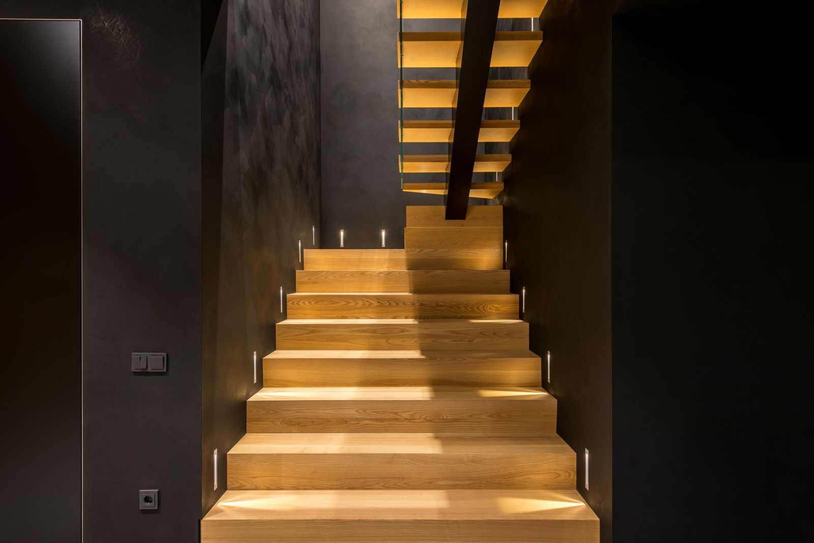 Softly lit oak staircase