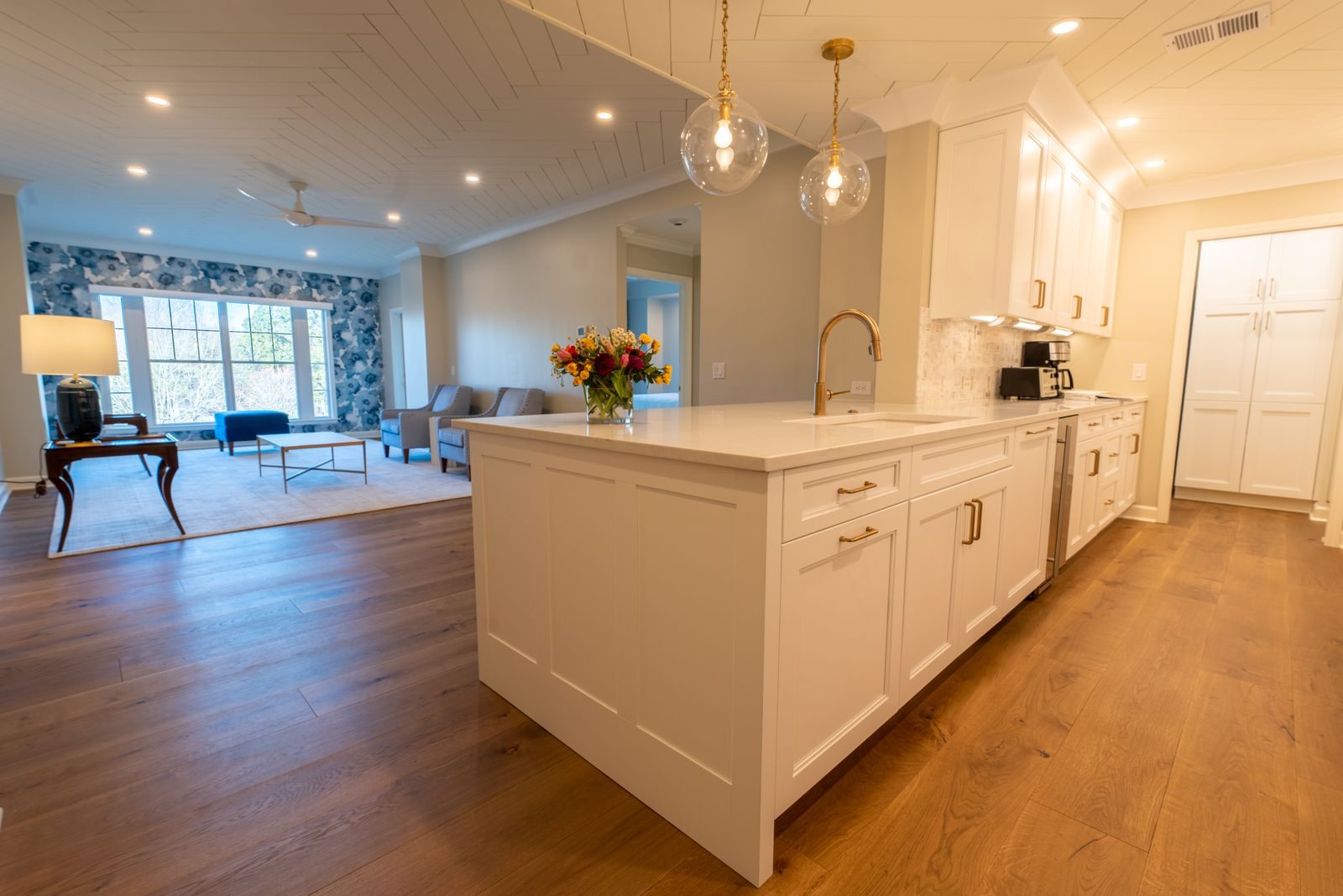 Open kitchen and living space with a warm oak floor