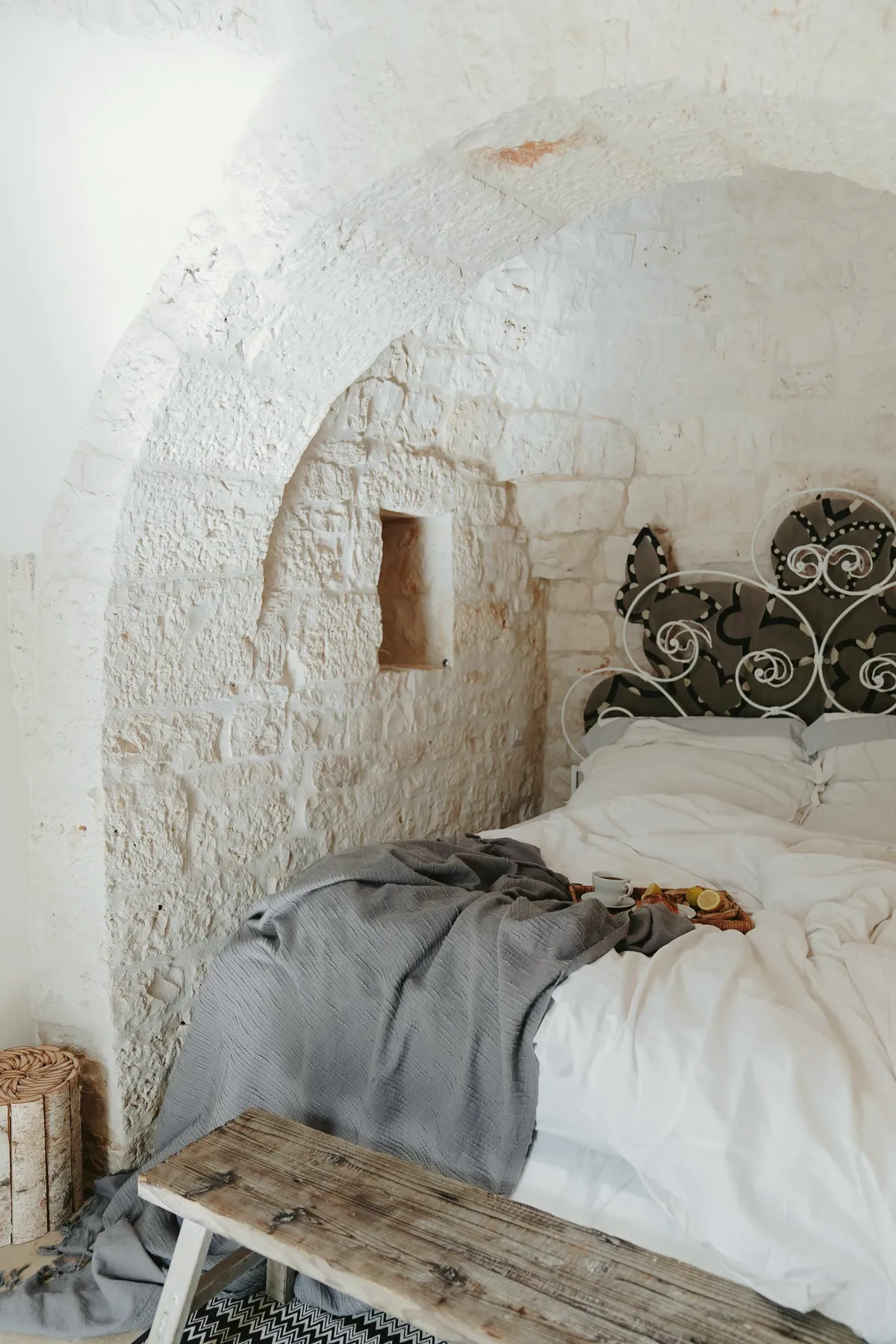 Bed under a whitewashed stone vault