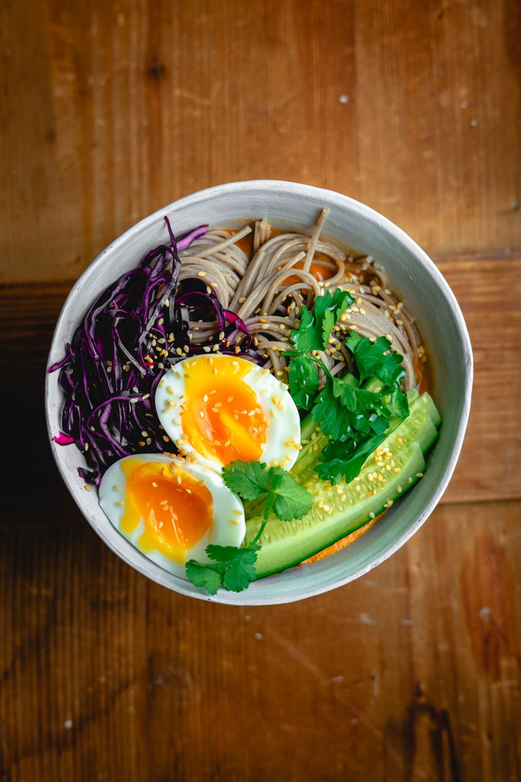 Vegetable noodle bowl with purple cabbage, cucumber and soft eggs